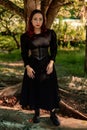 Young caucasian dark haired girl with red streaks in black dress outfit
