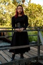 Young caucasian dark haired girl with red streaks in black dress outfit