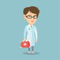 Young caucasian doctor holding a first aid box. Royalty Free Stock Photo