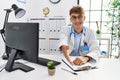 Young caucasian doctor man working at the clinic smiling friendly offering handshake as greeting and welcoming Royalty Free Stock Photo