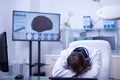 Young caucasian doctor sitting at this desk in the hospital with his heand on the desk sleeping Royalty Free Stock Photo
