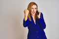 Young caucasian elegant business woman talking on the phone over isolated background annoyed and frustrated shouting with anger, Royalty Free Stock Photo