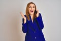 Young caucasian elegant business woman talking on the phone over isolated background very happy and excited, winner expression Royalty Free Stock Photo