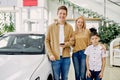 Young family with child happy after getting keys from their new car Royalty Free Stock Photo