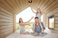 Young Caucasian family couple with baby daughter in a small modern rustic house with a large window. Lying on the bed Royalty Free Stock Photo