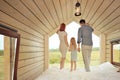 Young Caucasian family couple with baby daughter in a small modern rustic house with a large window. Lying on the bed Royalty Free Stock Photo