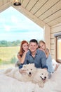 Young Caucasian family couple with baby daughter in a small modern rustic house with a large window. Lying on the bed Royalty Free Stock Photo