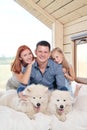 Young Caucasian family couple with baby daughter in a small modern rustic house with a large window. Lying on the bed Royalty Free Stock Photo