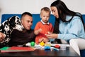 Young Caucasian family with a dog do creative work at home Royalty Free Stock Photo