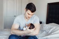 Young Caucasian father dad with his newborn mixed race Asian Chinese baby. Male man parent holding child daughter son. Royalty Free Stock Photo