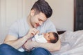 Young Caucasian father dad with his newborn mixed race Asian Chinese baby. Male man parent holding child daughter son. Royalty Free Stock Photo