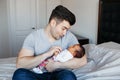 Young Caucasian father dad with his newborn mixed race Asian Chinese baby