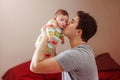 Young Caucasian father hugging and kissing newborn baby. Royalty Free Stock Photo