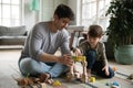 Young Caucasian father and small son playing at home Royalty Free Stock Photo