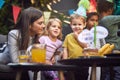 Young caucasian female amusing group of children at birthday party