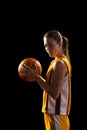 Young Caucasian female basketball player poses confidently in basketball attire, with copy space on Royalty Free Stock Photo