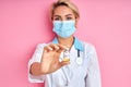 Young caucasian female doctor holding vaccine bottle in hand Royalty Free Stock Photo