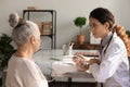 Female doctor examine elderly woman patient in hospital Royalty Free Stock Photo