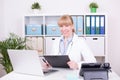 Young Caucasian female doctor working in her office Royalty Free Stock Photo