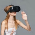 Young caucasian female experiencing virtual reality with vr headset against Royalty Free Stock Photo