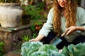 Young caucasian female gardener planting vegetables smiling happily close-up shot. Junior cheerful woman with trowel in