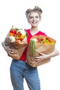 Young Caucasian Female Holding Eco Paper Bag Filled With Multiple Vegetables and Groceries Posing With Positive Facial Expression