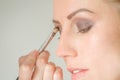 Young caucasian female model at a makeup. Applying make up to a Royalty Free Stock Photo