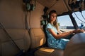Young Caucasian female passenger sitting in helicopter cockpit