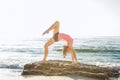 Young caucasian female practicing yoga on the seaside Royalty Free Stock Photo