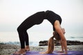 Young caucasian female practicing yoga on the seaside during the Royalty Free Stock Photo