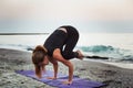 Young caucasian female practicing yoga on the seaside Royalty Free Stock Photo