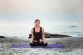 Young caucasian female practicing yoga on the seaside Royalty Free Stock Photo