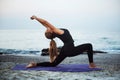Young caucasian female practicing yoga on the seaside Royalty Free Stock Photo