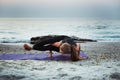 Young caucasian female practicing yoga on the seaside Royalty Free Stock Photo