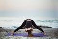 Young caucasian female practicing yoga on the seaside Royalty Free Stock Photo