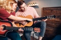 Young caucasian female show how to play the guitar Royalty Free Stock Photo