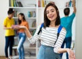 Young caucasian female student with group of students Royalty Free Stock Photo