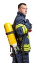 Young caucasian firefighter posing in profile with Full Facepiece Respirator and Breathing Air Cylinder Assembly