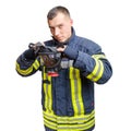 Young caucasian fireman in uniform puts full facepiece respirator over his head