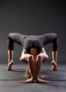 young caucasian girl in black sportswear doing yoga or pilates exercise. Healthy and active lifestyle. Asana practice