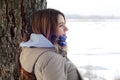 A young Caucasian girl in a brown coat staring into the distance on the horizon line Royalty Free Stock Photo