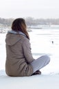 A young Caucasian girl in a brown coat staring into the distance on the horizon line Royalty Free Stock Photo