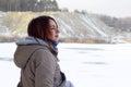 A young Caucasian girl in a brown coat staring into the distance on the horizon line Royalty Free Stock Photo