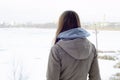 A young Caucasian girl in a brown coat staring into the distance on the horizon line Royalty Free Stock Photo