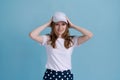 Young caucasian girl in delivery uniform and white cap looks confident