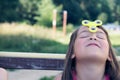 Young caucasian girl play with fidget spinner stress relieving toy on her forehead. Royalty Free Stock Photo