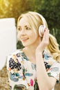 Young Caucasian Girl Smiles While Listening to Music on Headphones Inspired Looking Away Warm Light