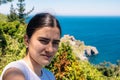 Young Caucasian girl taking a selfie with her cell phone as a souvenir at the viewpoint of the San Juan de Gastelugatxe Sanctuary Royalty Free Stock Photo