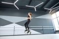 Young athlete practicing kangoo jumps in hall.