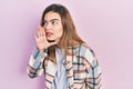 Young caucasian girl wearing casual clothes hand on mouth telling secret rumor, whispering malicious talk conversation Royalty Free Stock Photo